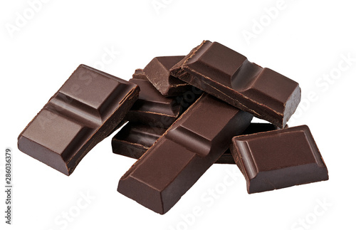 Dark chocolate pieces isolated on white background.