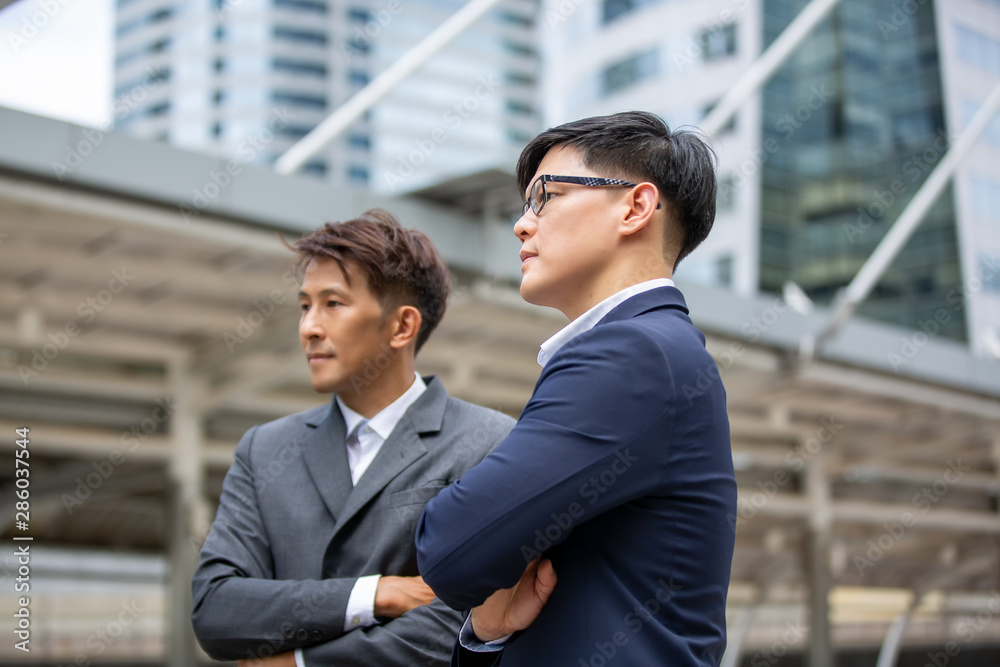 Two businessmen talking at outdoor against building Two businessmen talking at outdoor against building