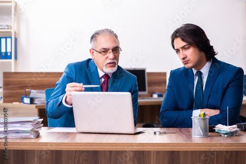 Young and old employees working together in the office