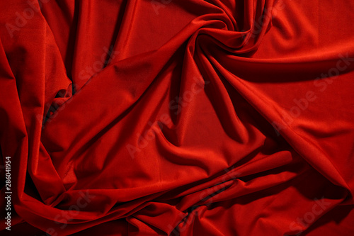 Background image of crumpled fabric. Red cloth
