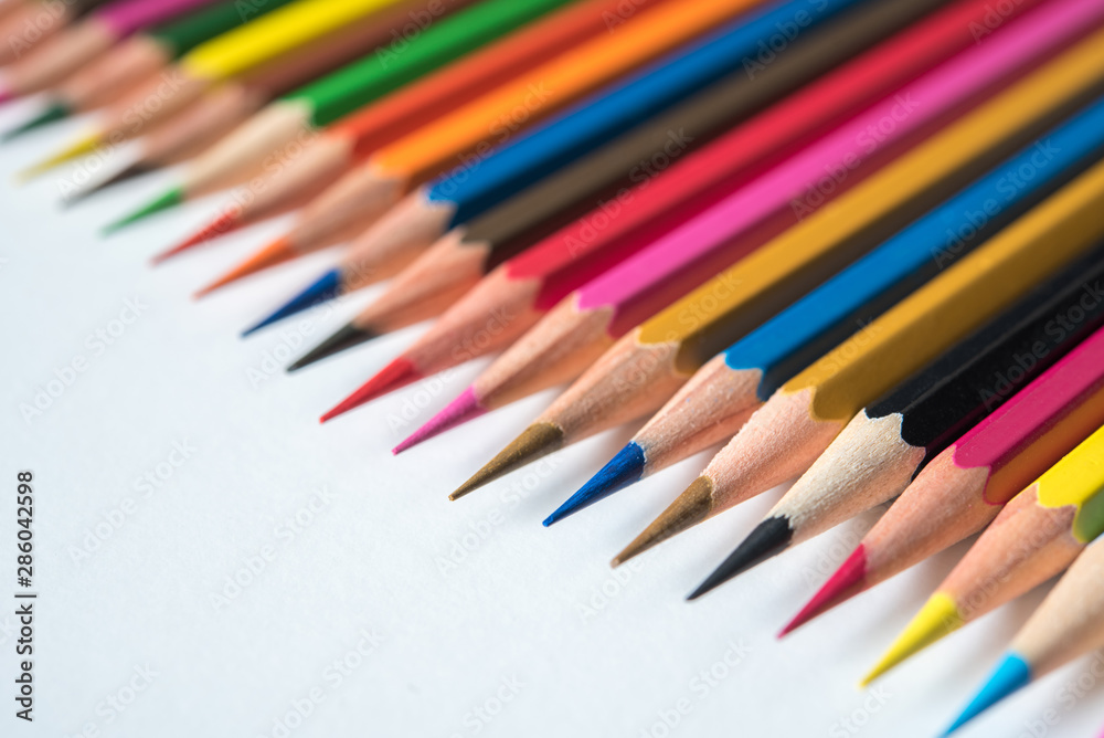 rows of multicolor pencil on white background