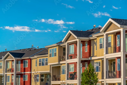 Lovely townhomes viewed against blue sky background on a sunny day