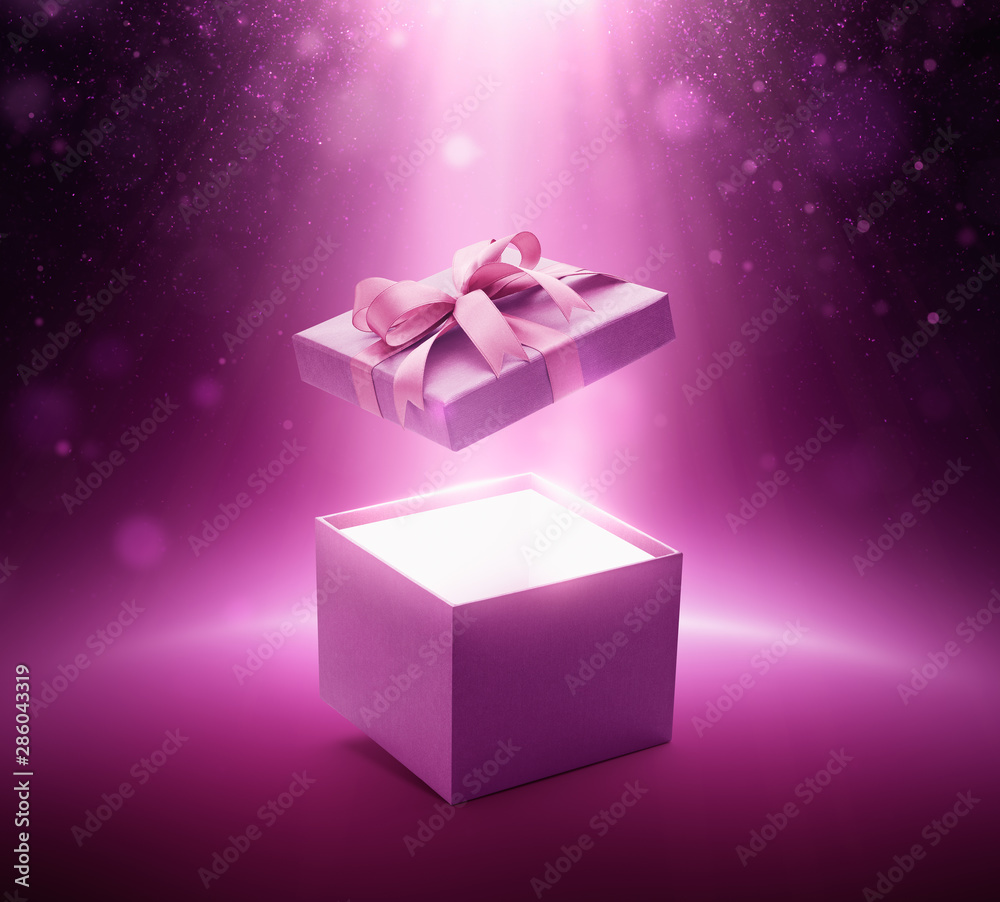 Purple color open gift box with ribbon on glittering background Purple color open gift box with ribbon on glittering background