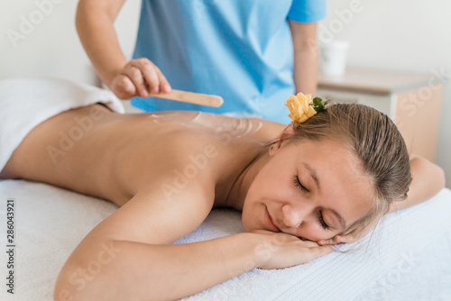 health  beauty  resort and relaxation concept - beautiful woman with closed eyes in Spa salon getting massage