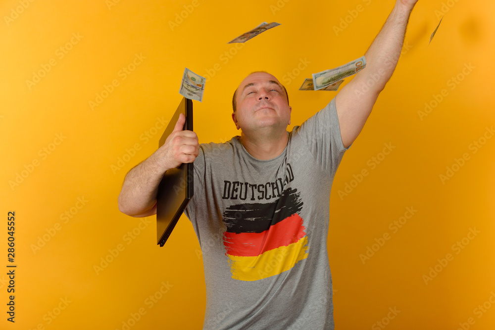 Joyful man with a laptop throws up money. Joyful man with a laptop throws up money.