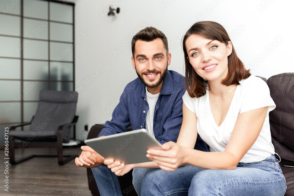 Positive couple using wifi at home Positive couple using wifi at home