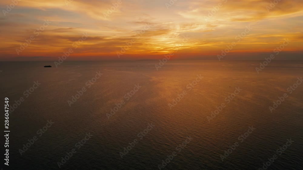 Colorful bright clouds during sunset over the sea, aerial view. Sunset over ocean. Boracay, Philippines. Seascape, Summer and travel vacation concept Colorful bright clouds during sunset over the sea, aerial view. Sunset over ocean. Boracay, Philippines. Seascape, Summer and travel vacation concept