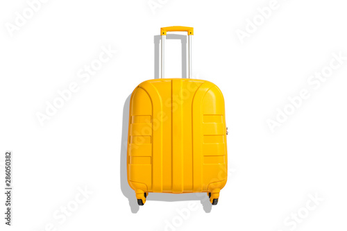Yellow suitcase on a white background. Travel and vacation concept. Flat lay, top view