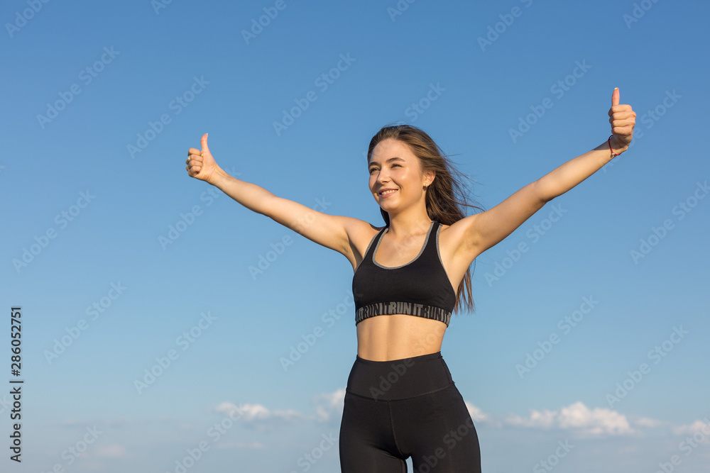 A young slim athletic girl in sportswear with snakeskin prints performs a set of exercises. Fitness and healthy lifestyle. A young slim athletic girl in sportswear with snakeskin prints performs a set of exercises. Fitness and healthy lifestyle.