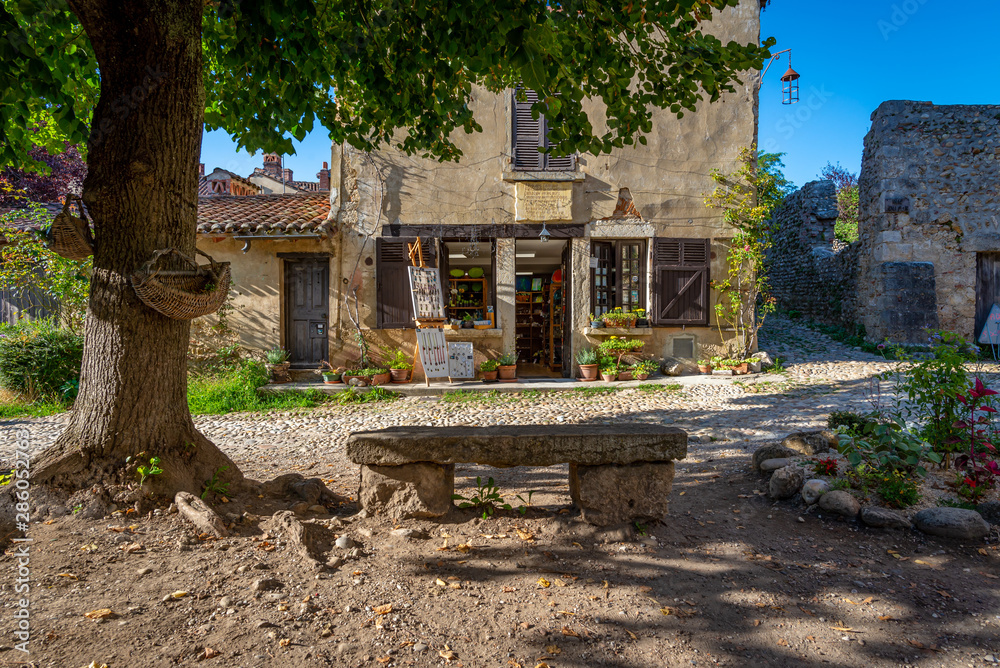 Old fashioned store with weathered stone bench, Perouges, France Old fashioned store with weathered stone bench, Perouges, France