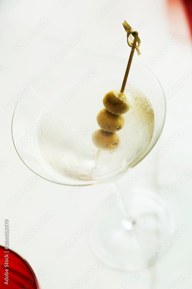 Dry martini with green olives on table Dry martini with green olives on table