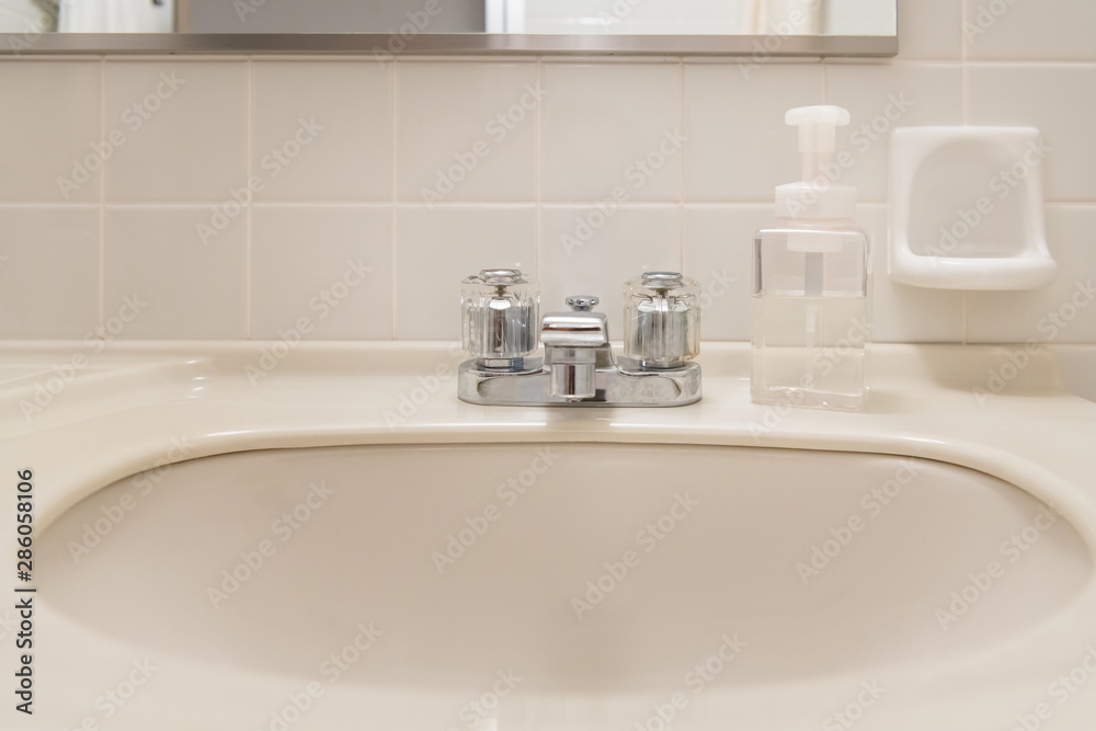 Washbasin and hand soap in the white bathroom of the hotel Washbasin and hand soap in the white bathroom of the hotel