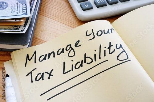 Business photo shows hand written text Manage Your Tax Liability
