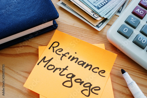 Text sign showing hand writed words refinance mortgage photo