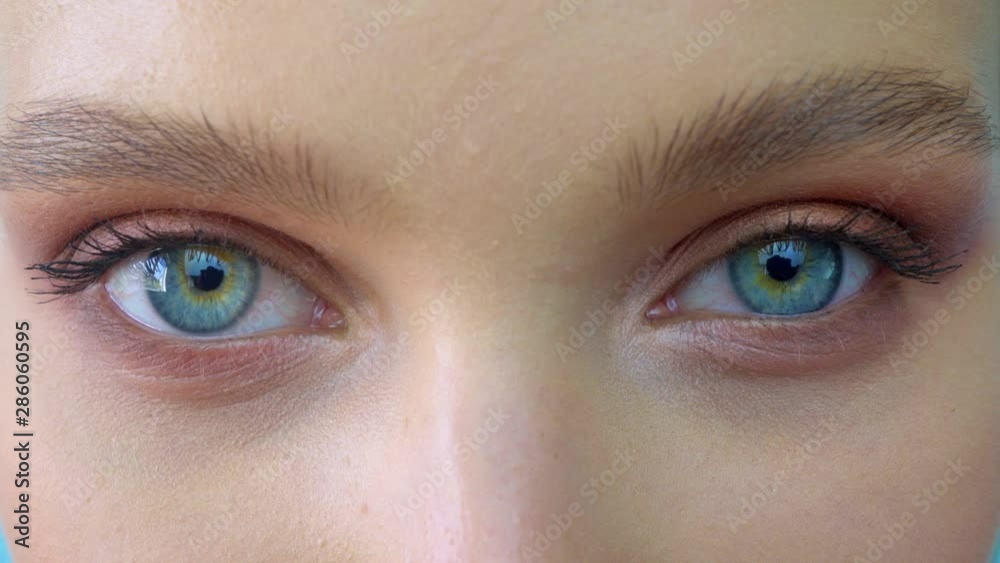 A close up portrait of beauty young beautiful woman's eyes, smiling looking at camera. 4 k. blue eyes of woman face, beautiful woman girl female portrait model, The girl's eye. opening her blue eyes