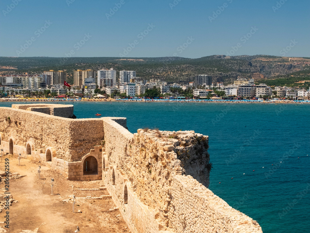 Walls of Maiden's castle or Kizkalesi or Deniz kalesi and view of sea and Kizkalesi town, Mersin province, Turkey