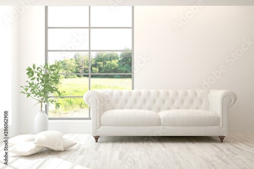 Stylish room in white color with sofa and summer landscape in window. Scandinavian interior design. 3D illustration