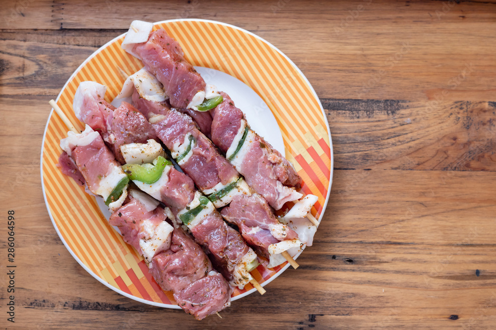 raw meat with herbs and garlic for grill on dish