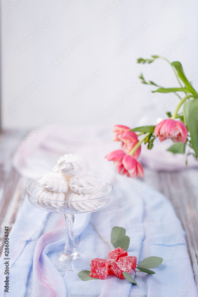 marshmallows in a glass stand and red marmalade marshmallows in a glass stand and red marmalade