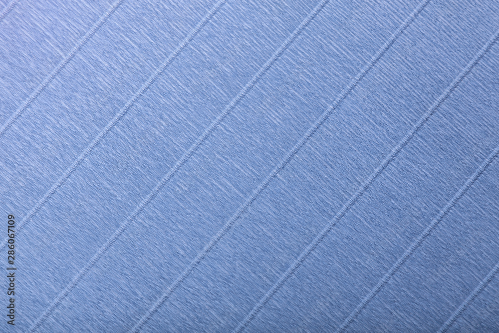 Fototapeta premium Textural of navy blue background of wavy corrugated paper, closeup.