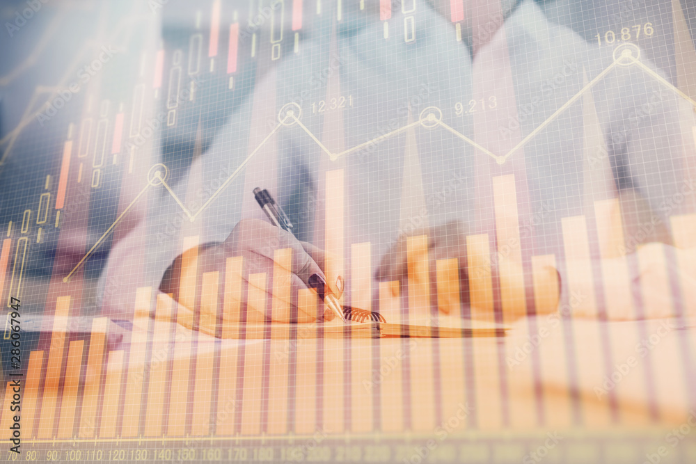 Financial chart drawn over hands taking notes background. Concept of research. Multi exposure Financial chart drawn over hands taking notes background. Concept of research. Multi exposure