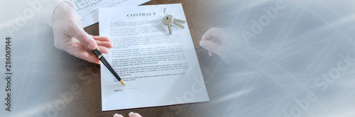 Realtor showing the signature place of a contract; panoramic banner