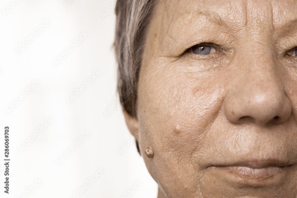 Elderly pensioner female half face portrait closeup Elderly pensioner female half face portrait closeup