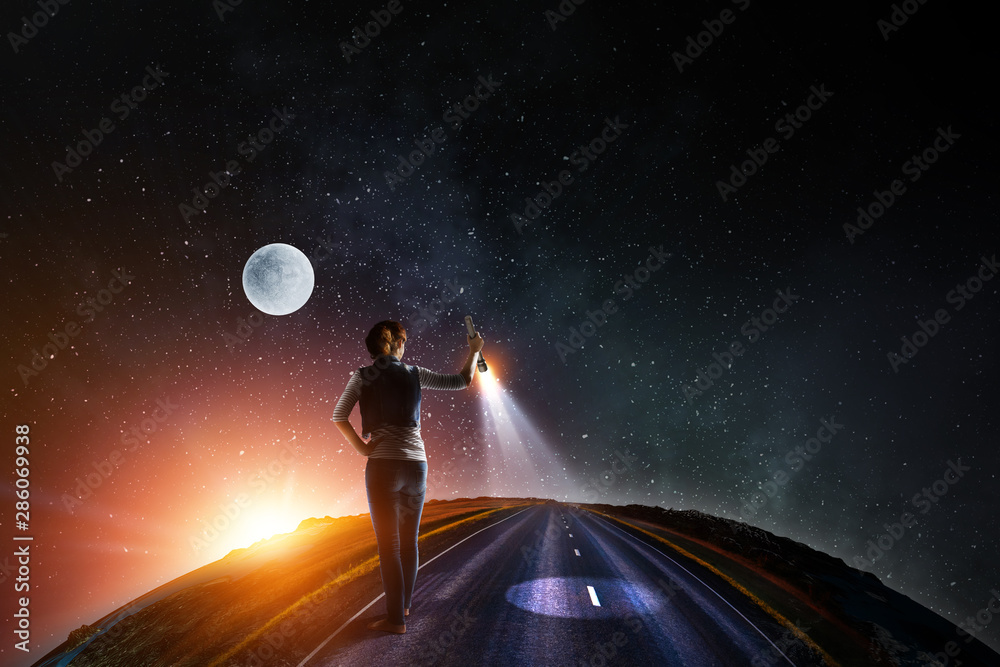 Young woman holding a flashlight