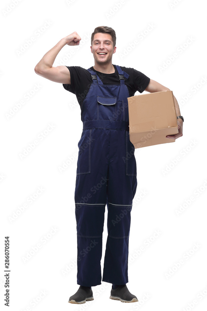 strong worker in overalls with a large cardboard box. isolated on white strong worker in overalls with a large cardboard box. isolated on white
