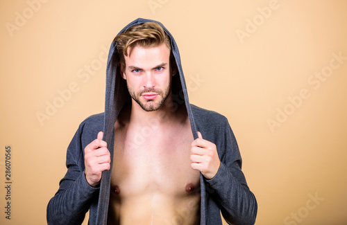 Brute masculinity extremely commanding looking conventionally handsome. Unconventional but masculine look. Masculinity concept. Masculinity and confidence. Man muscular torso wear hooded clothes photo