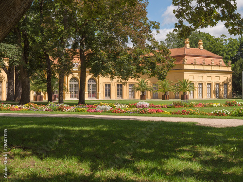 orangery through trees baroque palace garden in Erlangen Bavaria, Germany