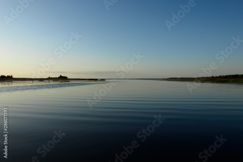 Scenic sunrise panorama view, morning fog on lake, misty reflection in steaming water, Latvia