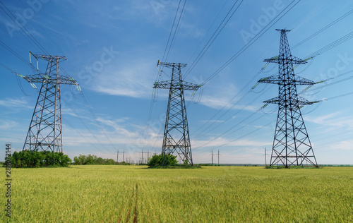 Canvastavla High voltage lines and power pylons and a green agricultural landscape on a sunny day