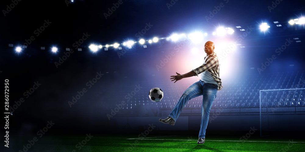 Soccer man in action with ball. Mixed media Soccer man in action with ball. Mixed media