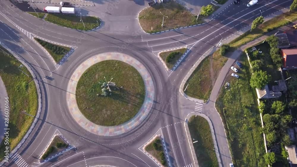 Top down aerial view of a traffic roundabout on a main road. Top down aerial view of a traffic roundabout on a main road.