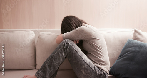 woman feel depressed on sofa