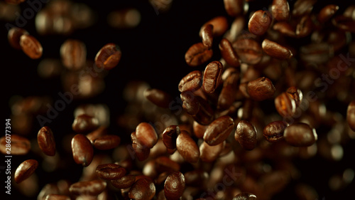 Fresh roasted coffee beans flying in the air