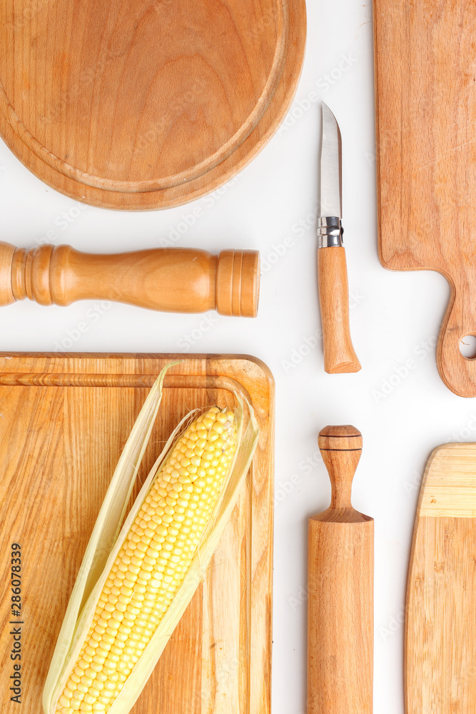 Composition of wooden cutting boards and wooden utensils and kitchen utensils. Top view.
