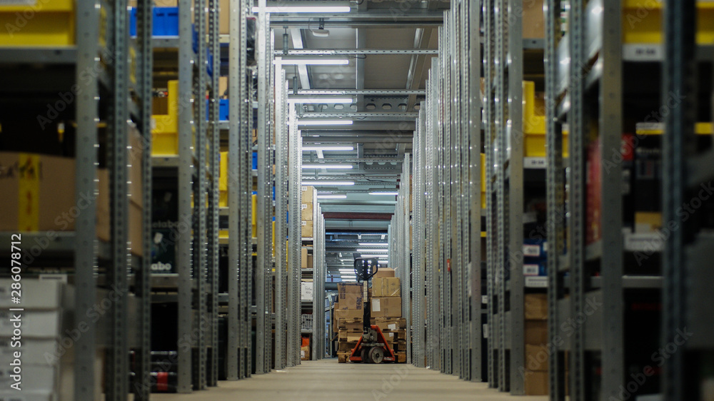 Storage area with boxes, shelves, pallet jack Storage area with boxes, shelves, pallet jack