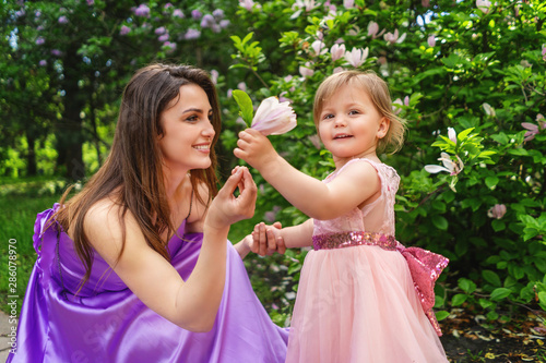 Little girl giving flower to her mom