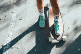 legs of teenage girl with longboard