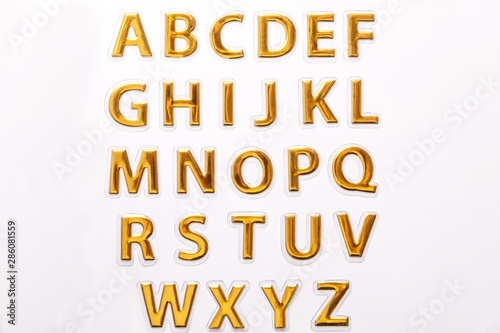 Set of shiny golden glossy letters, isolated on white background.