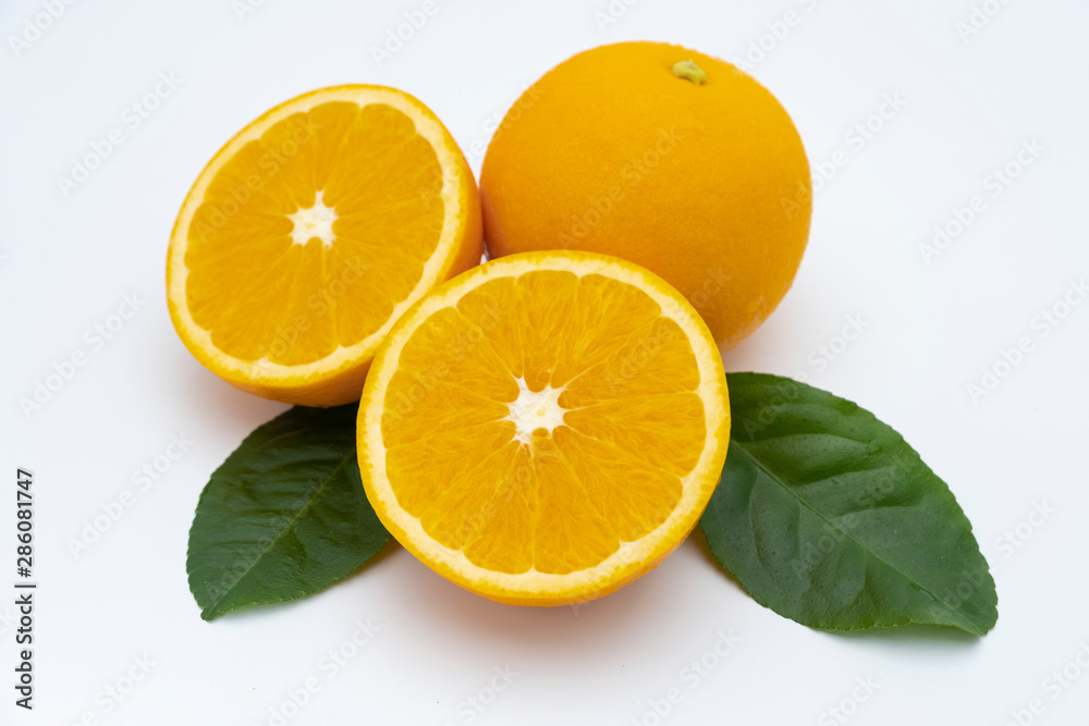 Half of orange and whole with green leaf isolated on white background Half of orange and whole with green leaf isolated on white background
