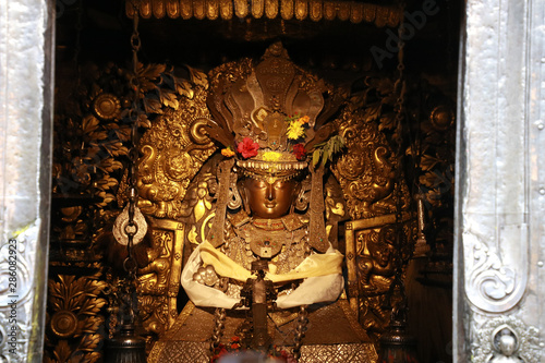 Buddhism god at golden temple or Kwal Bahal temple in nepali unique Buddhist monastery located on north of Patan Durbar Square,Kathmandu,Nepal photo