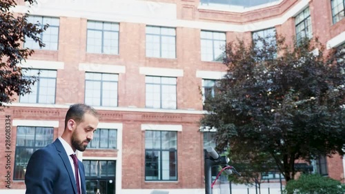 Wallpaper Mural Businessman in formal suit outdoor typing on the laptop sitting in a business district. Panning down shot Torontodigital.ca