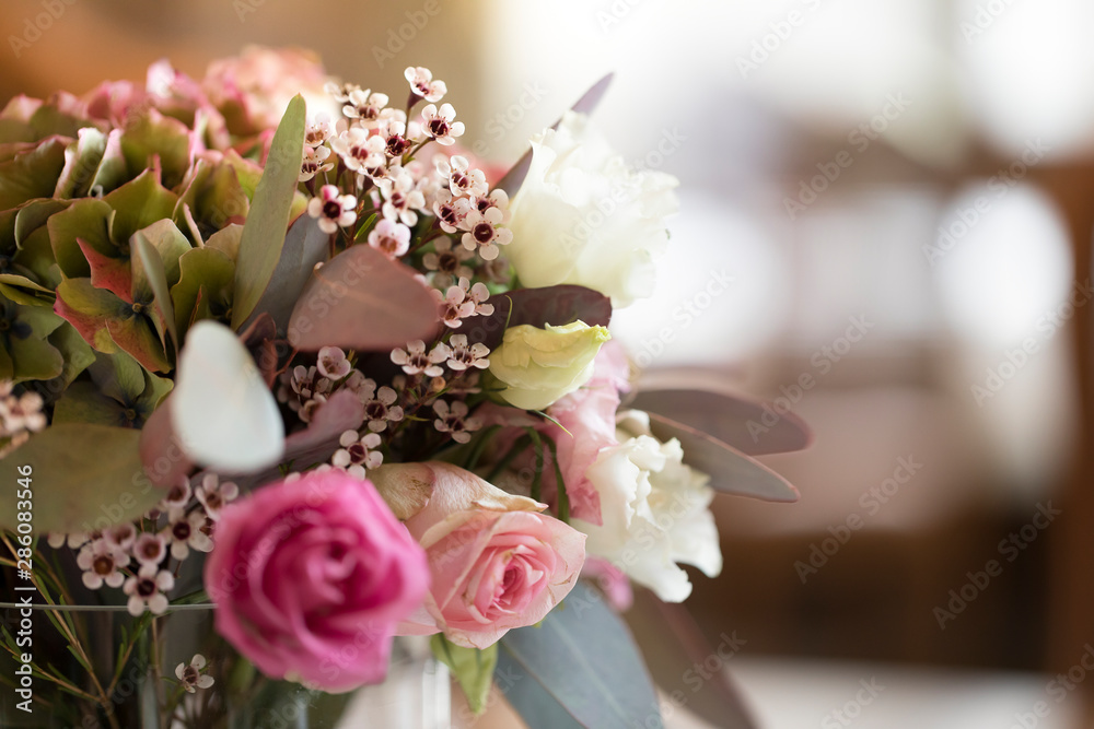 Fototapeta premium floral bouquet with eucalyptus leaves and pink roses with a blurred background