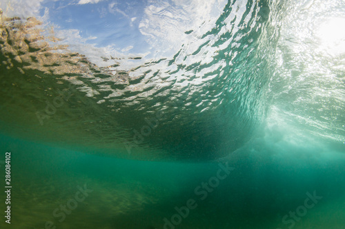underwater wave crashing on a sandy ocean floor © Ryan