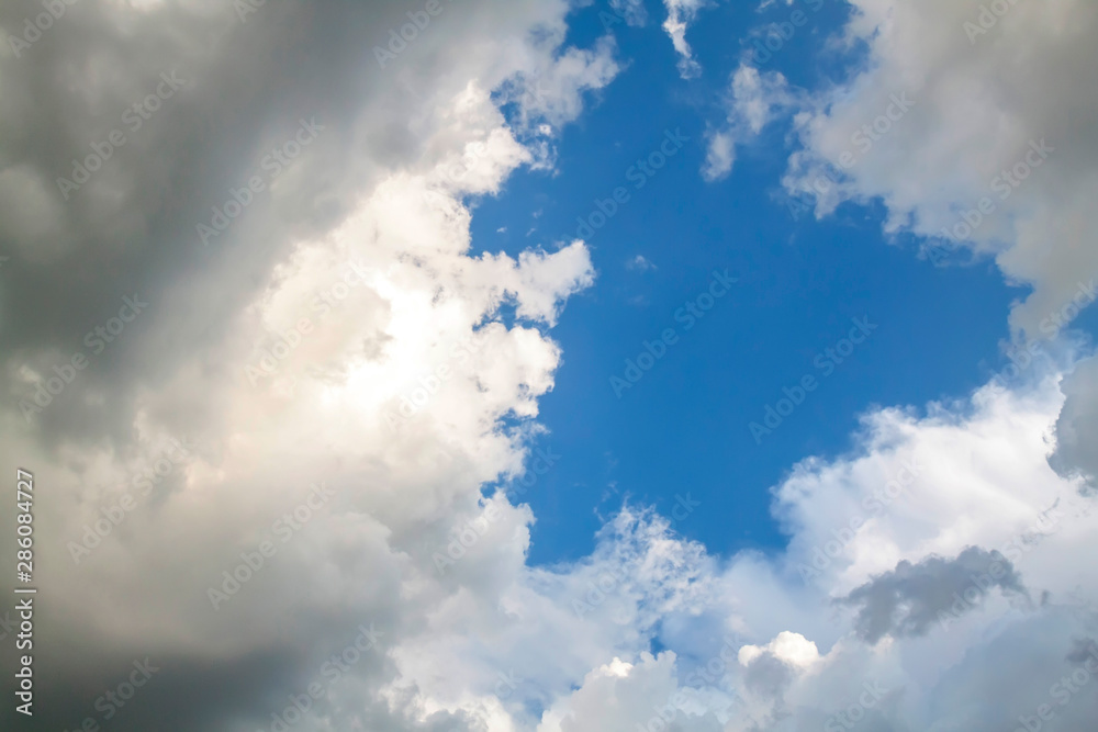 Cumulus clouds gather before the rain against a clear blue sky. Natural landscape. Cumulus clouds gather before the rain against a clear blue sky. Natural landscape.