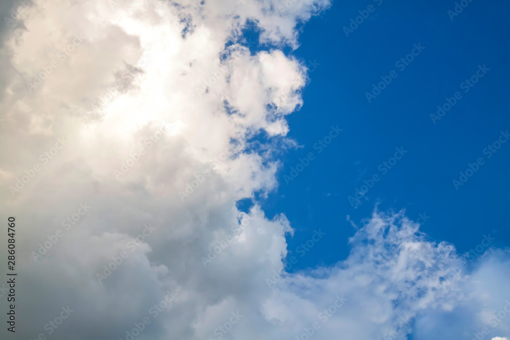Cumulus clouds gather before the rain against a clear blue sky. Natural landscape. Cumulus clouds gather before the rain against a clear blue sky. Natural landscape.