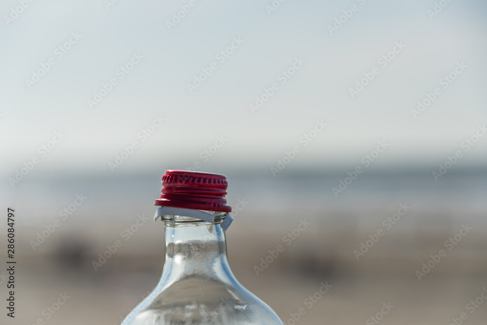 Opened bottle red closure against blury background